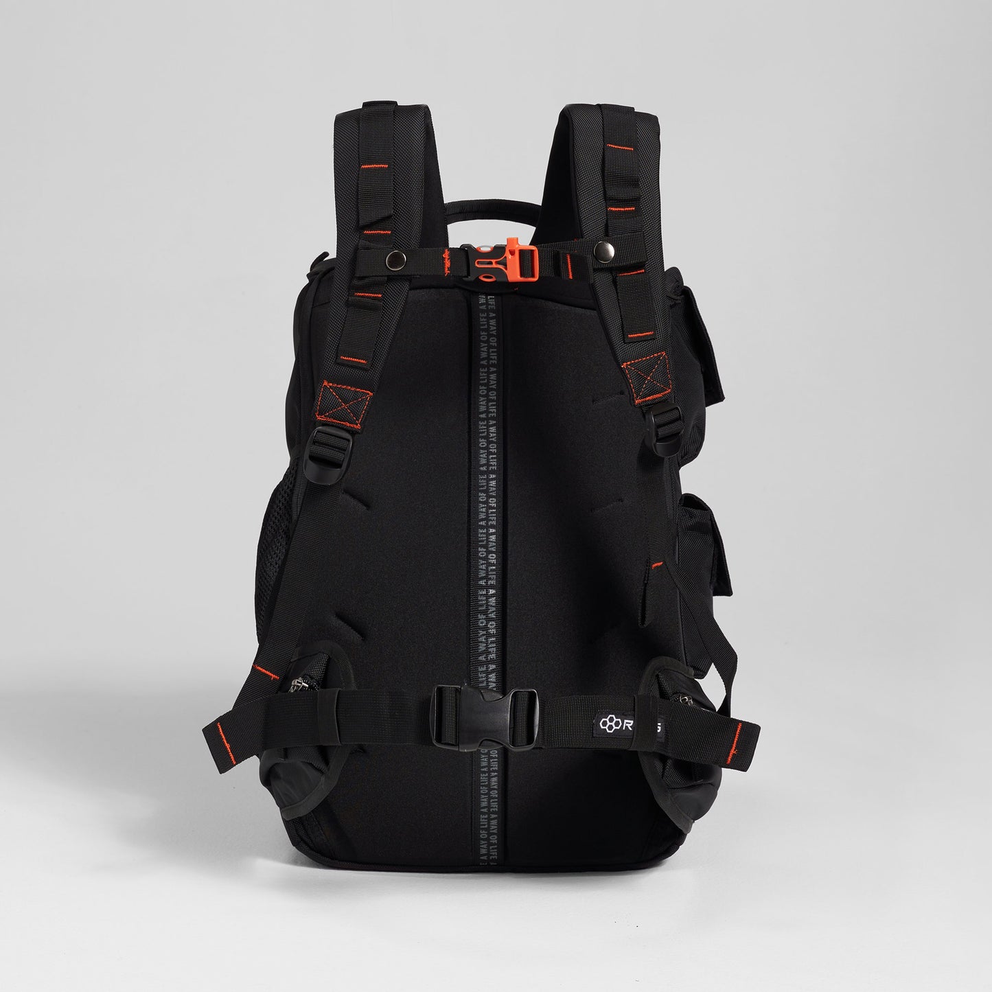 A modern black backpack with vibrant orange accents featuring padded shoulder straps adjustable buckles and multiple storage compartments