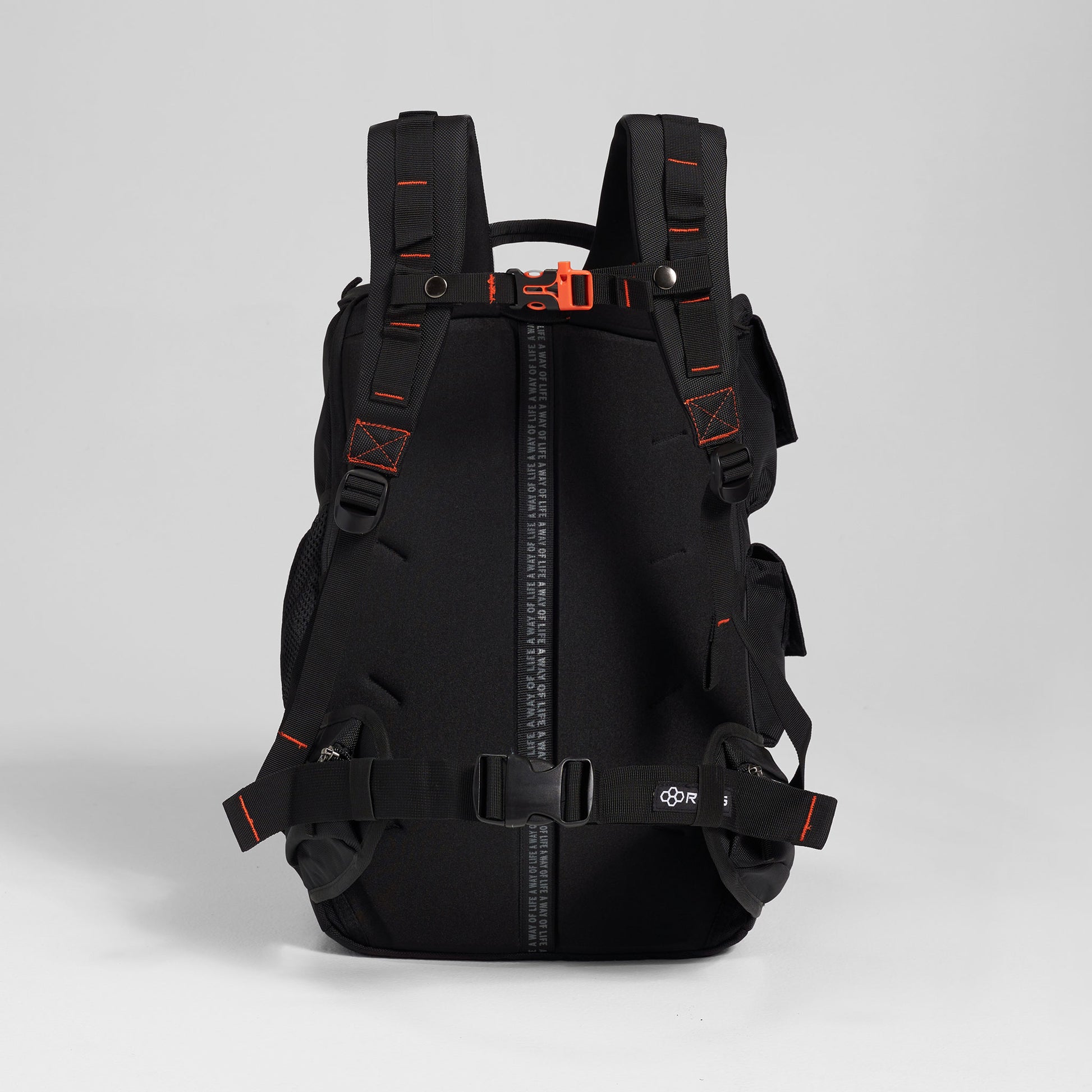 A modern black backpack with vibrant orange accents featuring padded shoulder straps adjustable buckles and multiple storage compartments