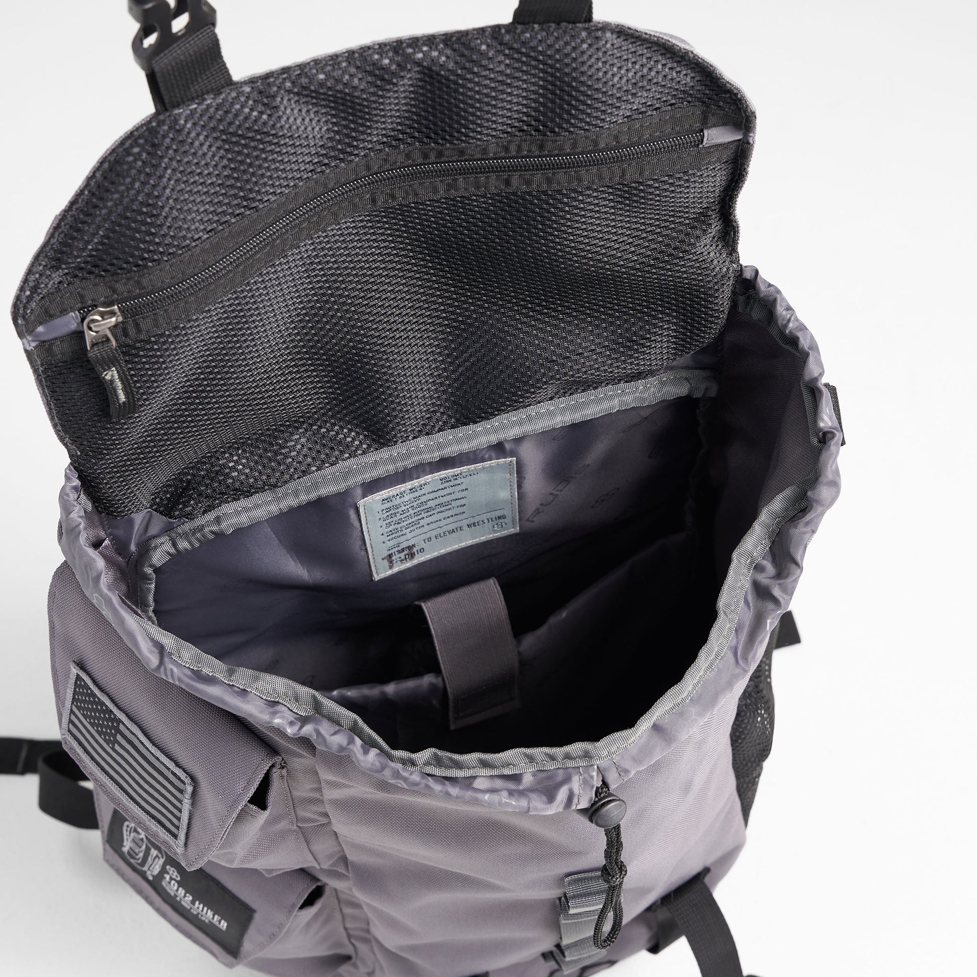 The interior view of a sleek gray backpack featuring multiple compartments and a versatile design suitable for outdoor activities