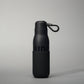 A stylish black insulated water bottle with a textured grip and a loop for carrying