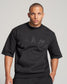 A serious-looking man wearing a black sweatshirt with CHAMP emblazoned on the front complemented by a stylish crew neckline and short sleeves