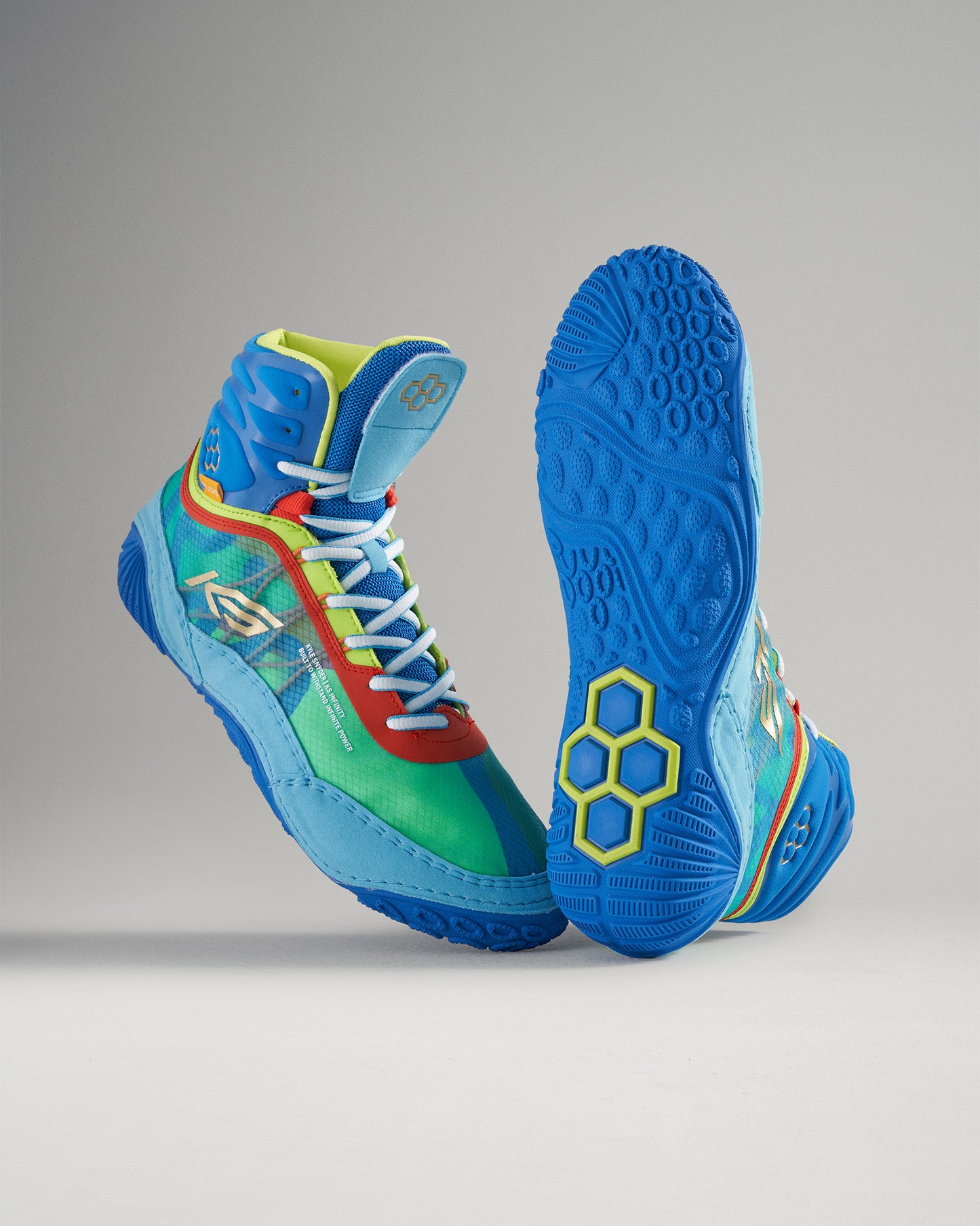 A pair of vibrant multicolored high-top basketball shoes featuring a mix of blue green yellow and red tones with a textured sole designed for traction