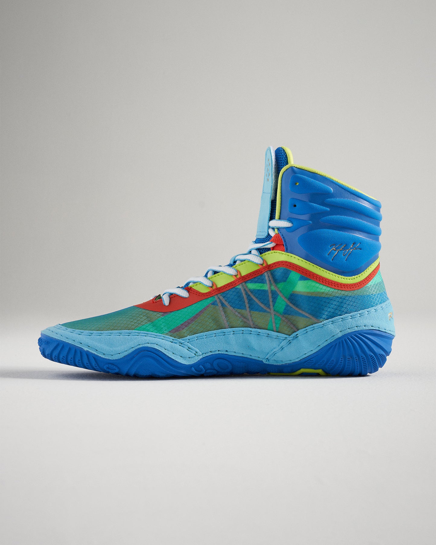 A vibrant pair of high-top athletic shoes featuring a multicolored mesh upper with blue green red and yellow accents designed for basketball performance