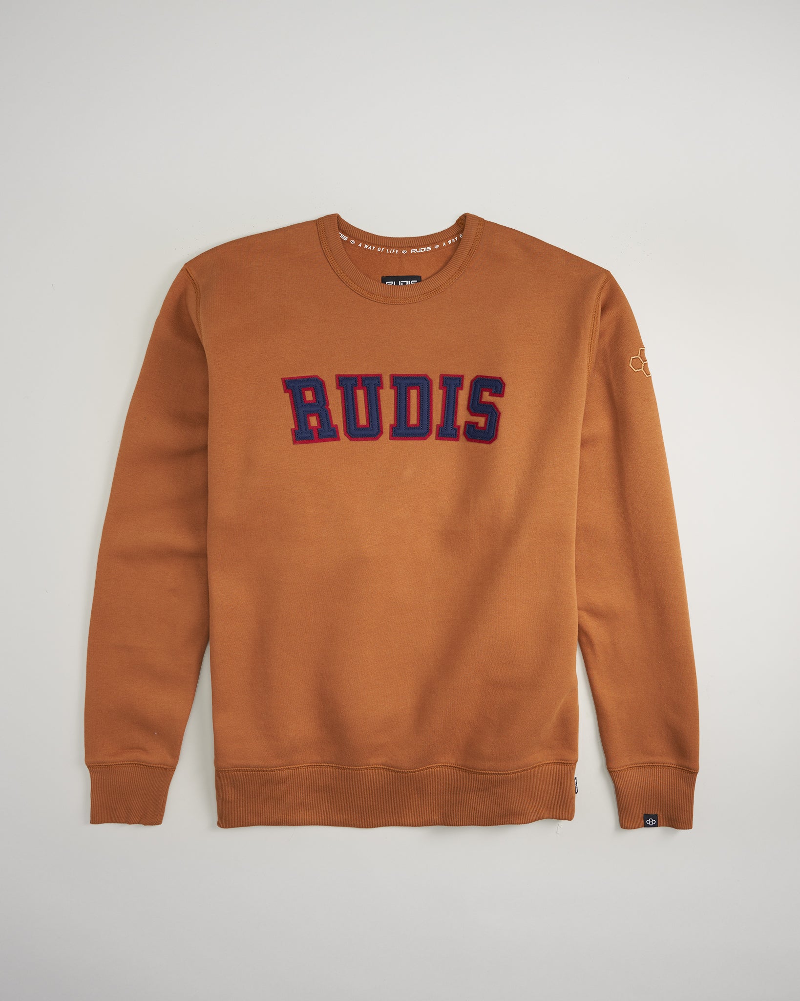 A stylish brown sweatshirt featuring bold RUDIS lettering in red and blue designed for comfort and casual wear