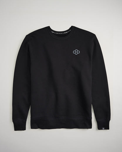 A black crewneck sweatshirt featuring a small stylized hexagon logo on the left chest area showcasing a clean and minimalist design