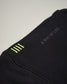 A close-up view of a black fabric with a green and gray logo highlighting modern athletic wear design