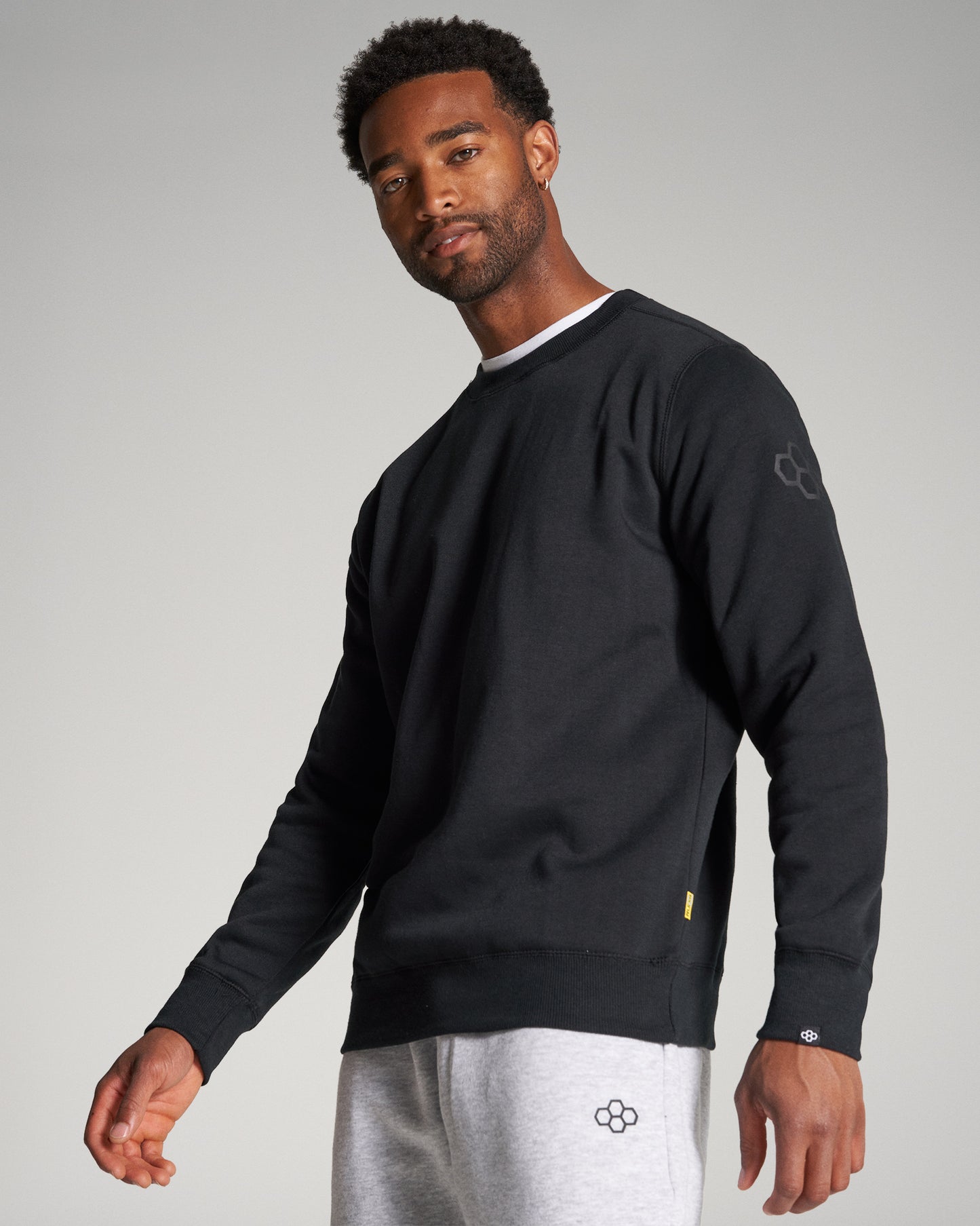 A stylish black sweatshirt paired with gray sweatpants showcasing modern fashion and comfort