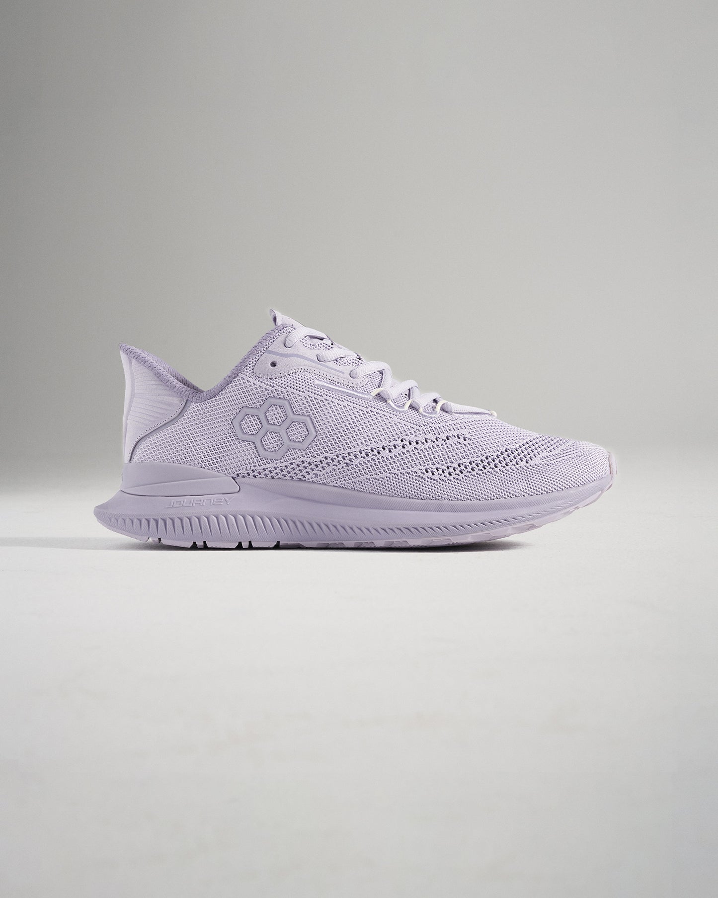 A side view of a light purple running shoe featuring a breathable mesh upper and a textured sole designed for comfort and performance