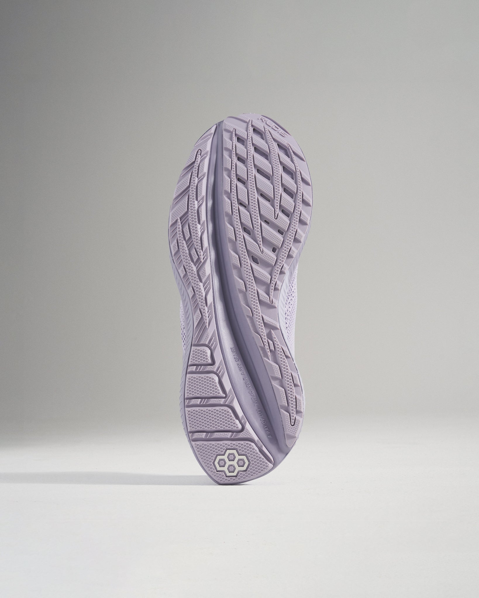 A stylish pair of light purple athletic shoes with a textured sole emphasizing performance and design