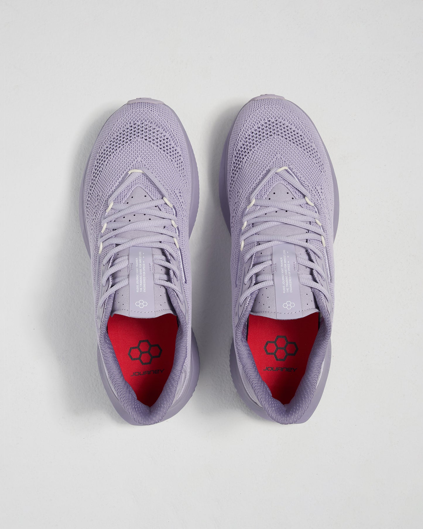 A pair of lavender running shoes featuring a breathable mesh upper contrasted by a vibrant red insole designed for comfort and style during athletic activities