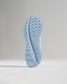 A close-up view of a light blue running shoe sole with an intricate tread pattern designed for grip and performance