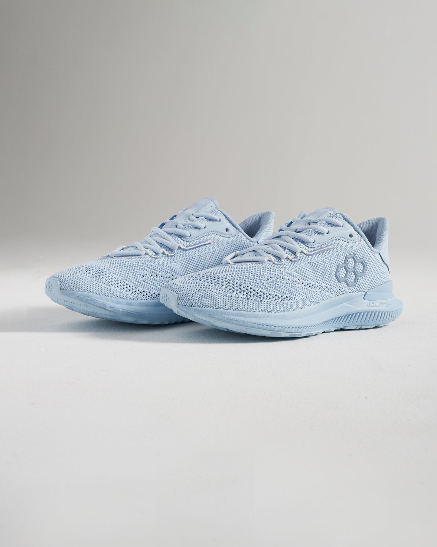 A pair of light blue running shoes featuring a breathable mesh upper and robust soles designed for comfort and performance in athletic activities