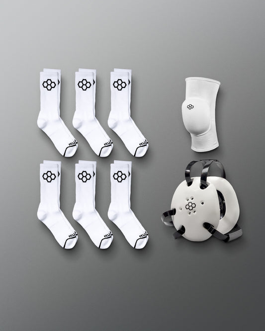 Eight pairs of white athletic socks with black logos and a white knee pad with a matching logo are arranged on a gray background, highlighting performance and support gear.