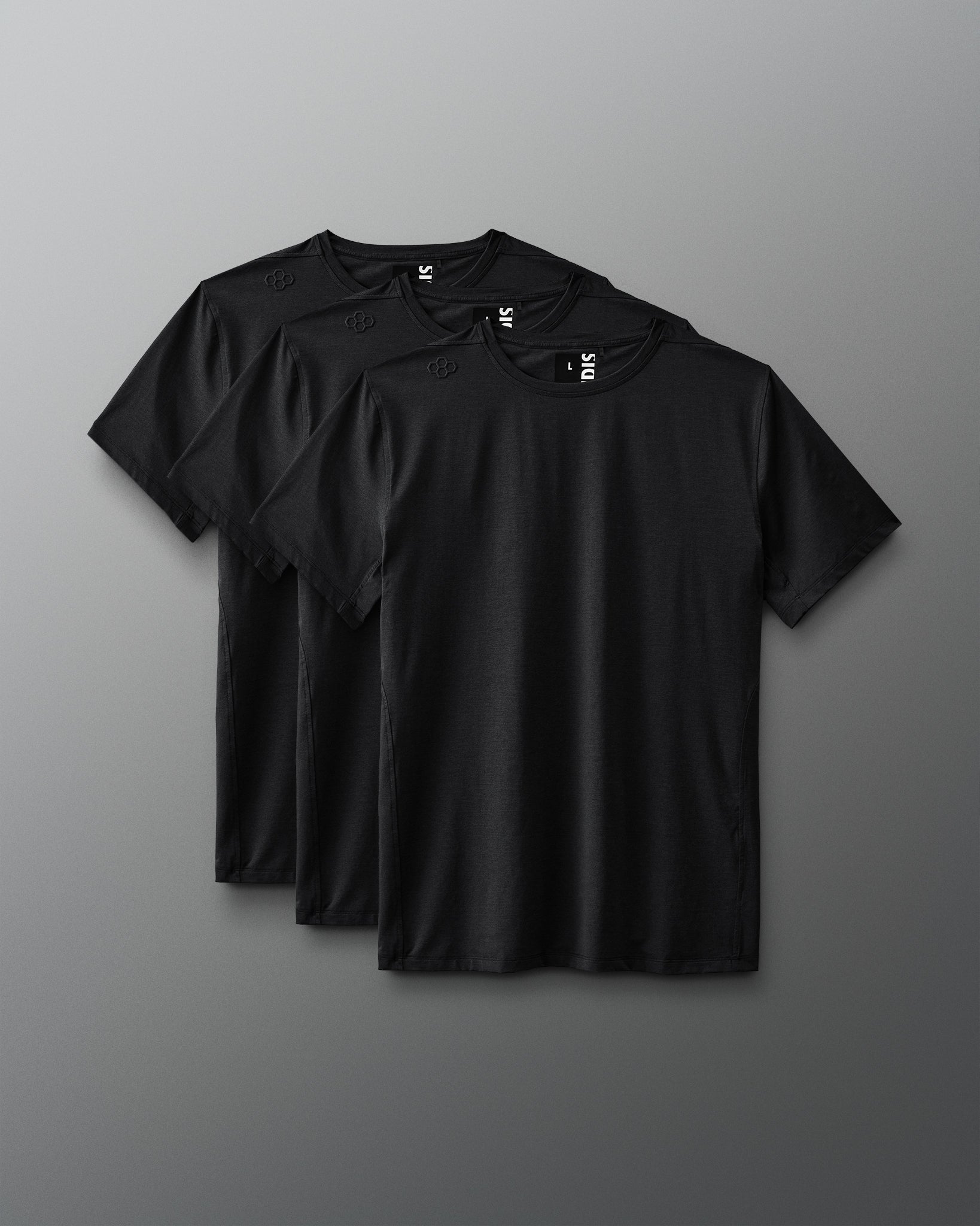 Three identical black t-shirts are neatly arranged side by side against a soft gray background, featuring round necklines and short sleeves, suitable for casual wear.