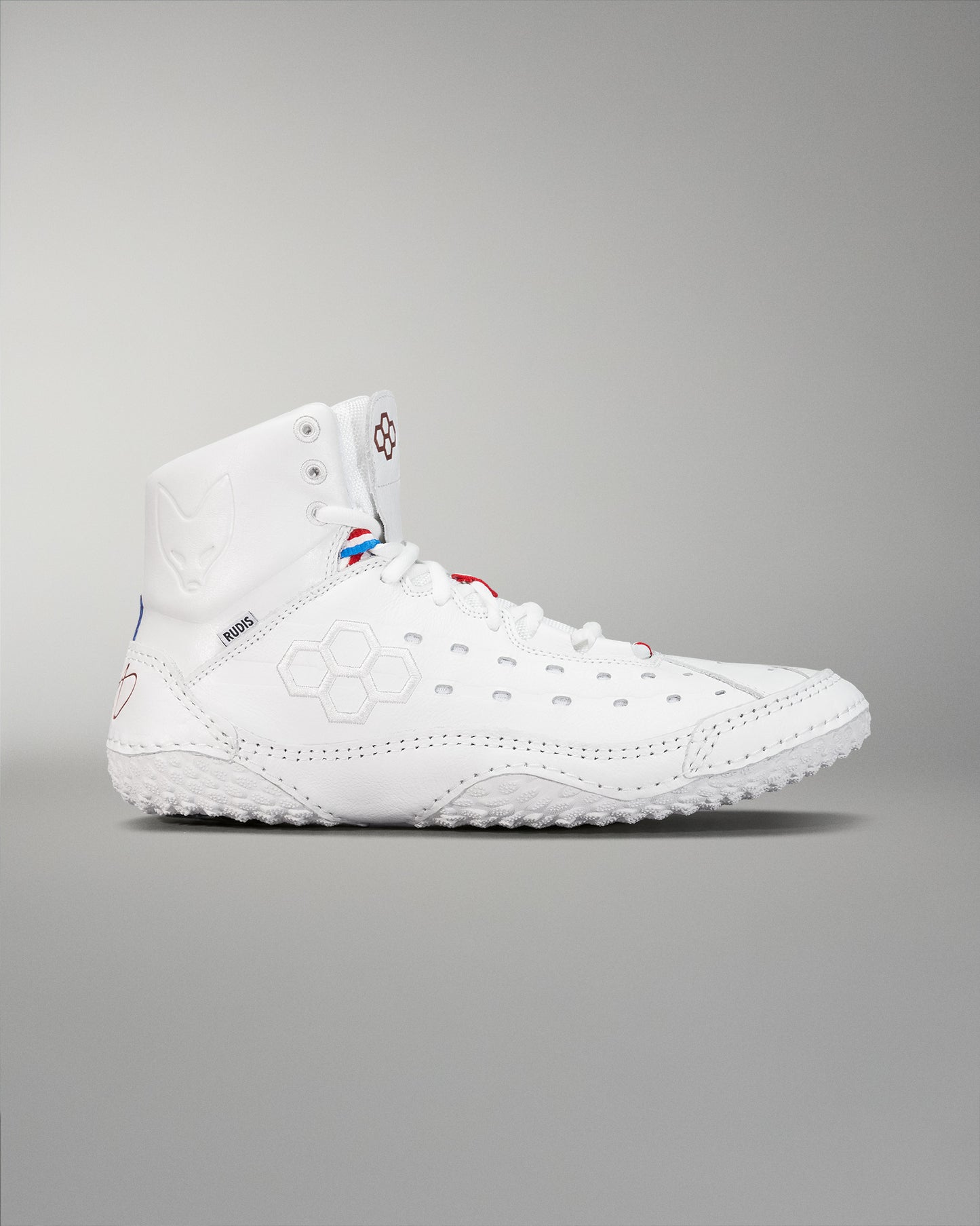 High-top athletic shoe mostly in white with red and blue accents, featuring a padded collar and a textured sole for optimal grip.