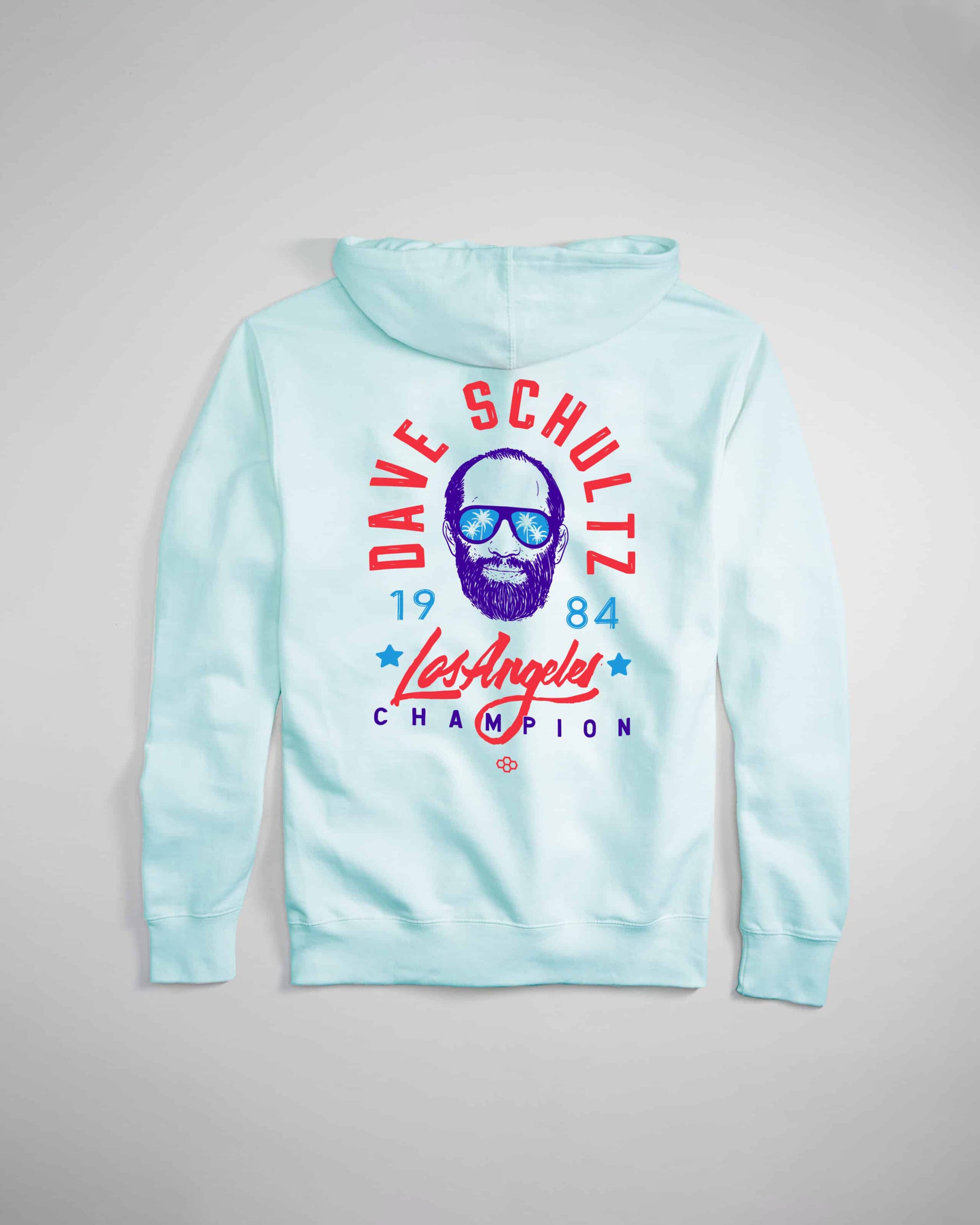 A light blue hoodie featuring a vibrant graphic of a bearded man wearing sunglasses with the text Dave Schultz 1984 Los Angeles Champion