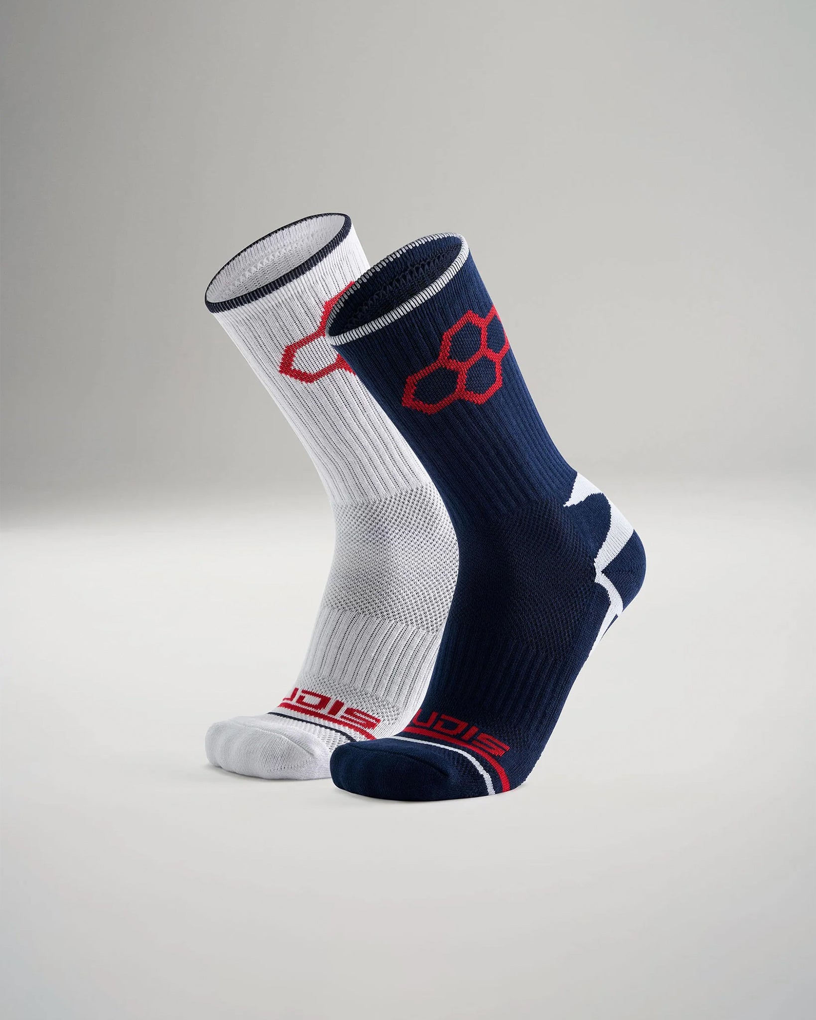 A pair of stylish athletic socks one in white and the other in navy blue showcasing a modern design with ribbed texture and contrasting logos