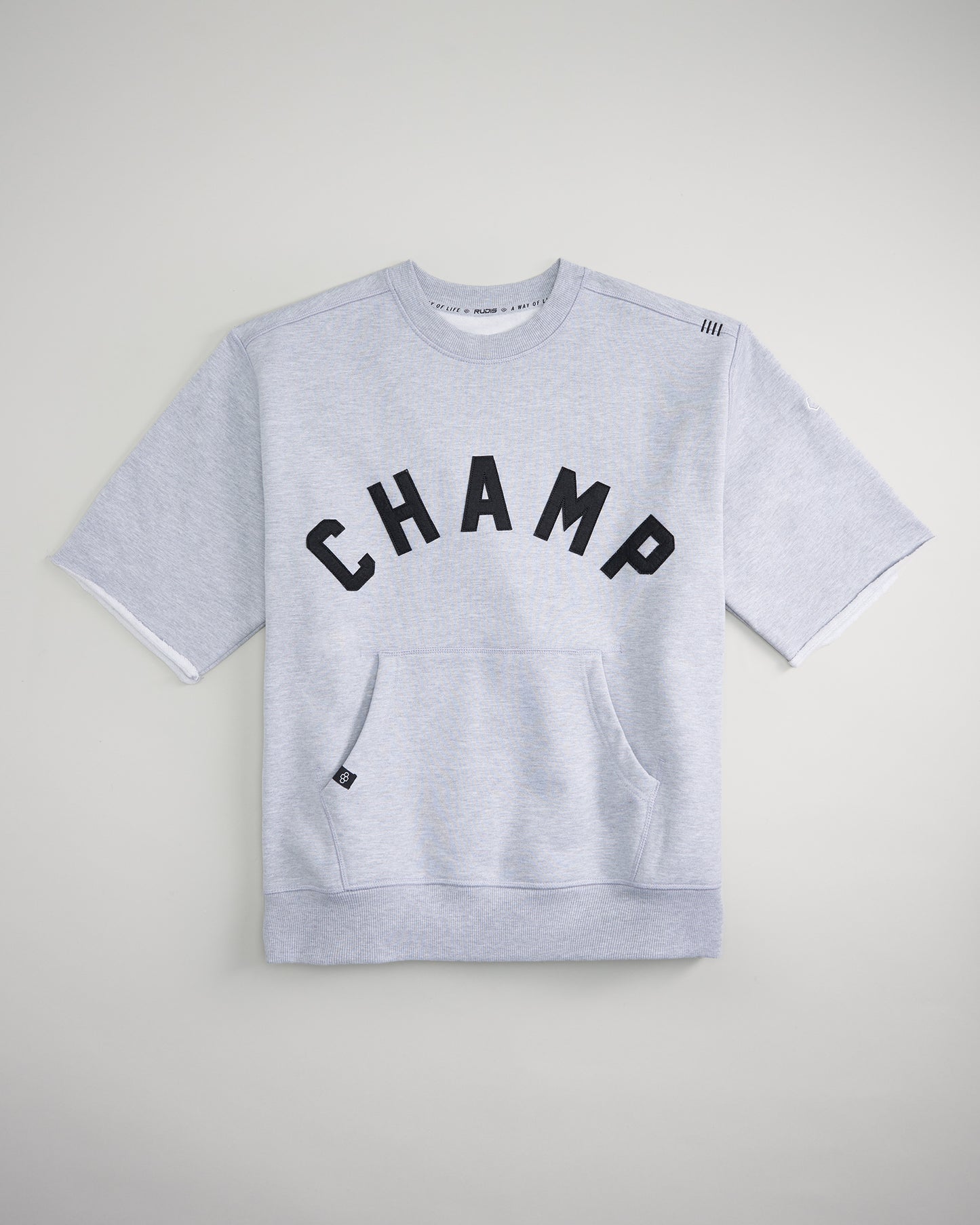 A gray sweatshirt with the word CHAMP printed in bold black letters across the front featuring a cozy hood and a front pocket