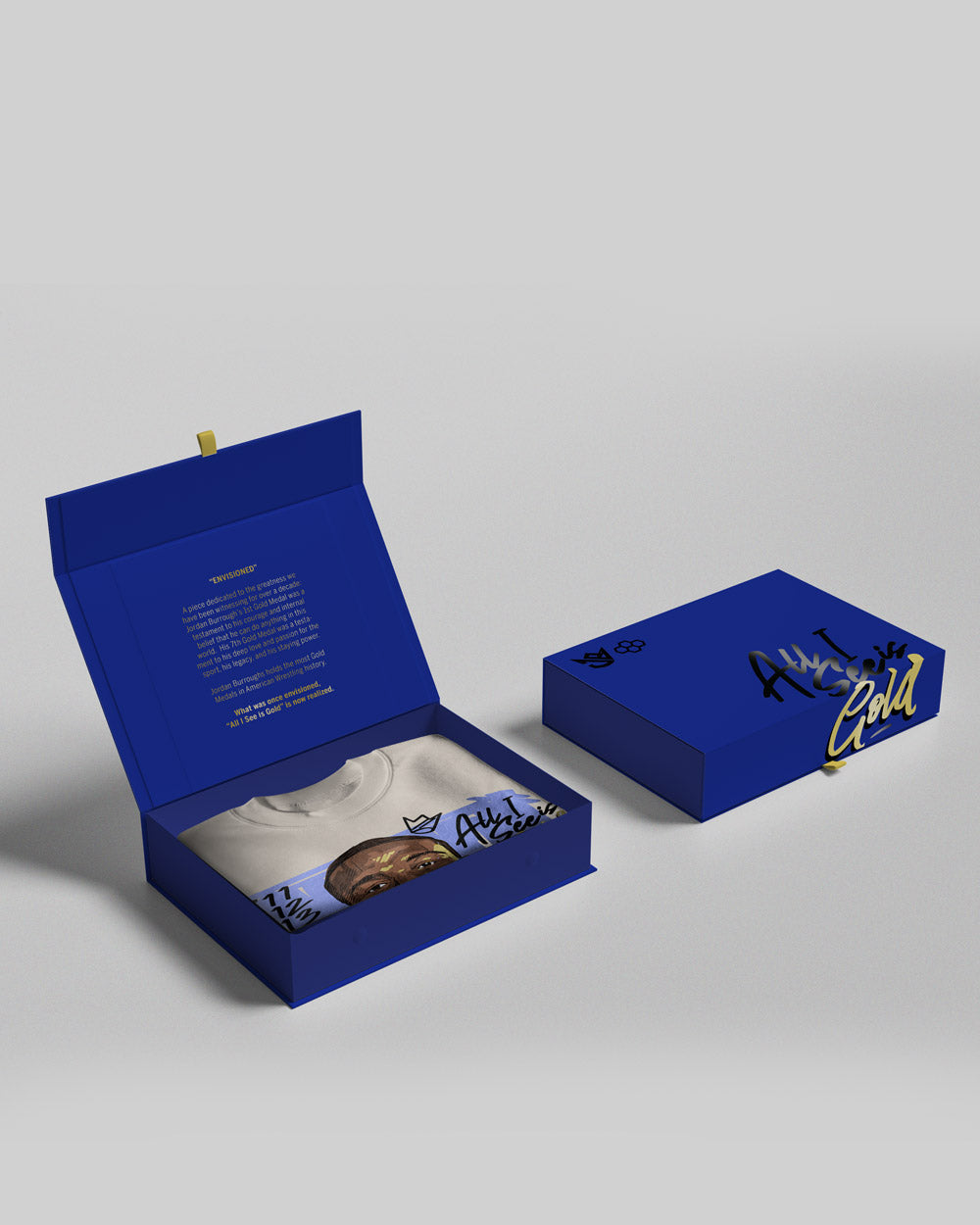 A vibrant blue packaging box containing a white T-shirt featuring artistic graphics including a face and stylized text