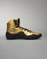 A striking gold basketball shoe with black accents showcasing a unique design and texture