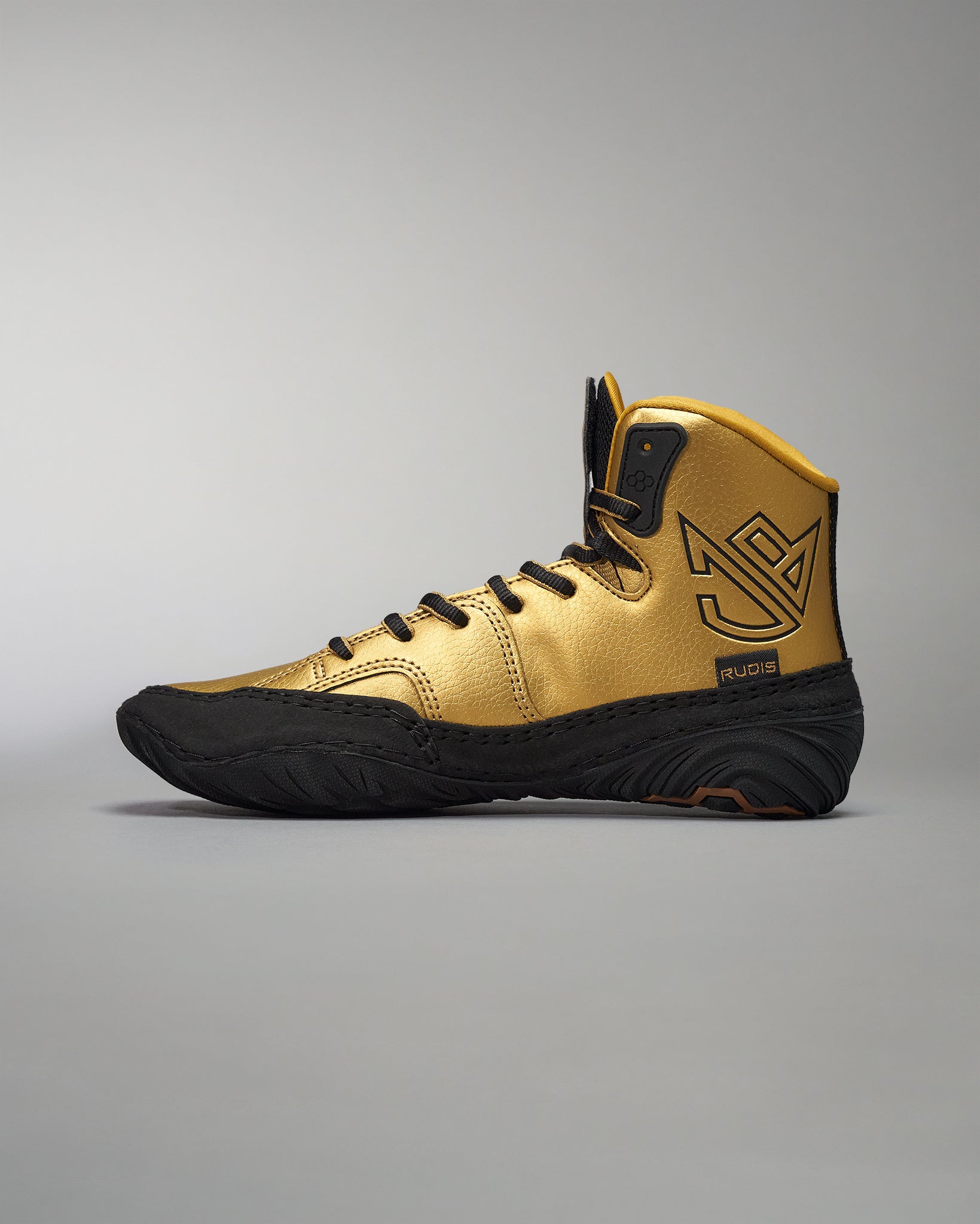 This image displays a gold and black wrestling shoe designed for performance and style featuring a high-top design textured detailing and branding