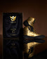 A stunning pair of gold and black athletic shoes displayed beside an elegant box that features motivational text highlighting their premium design and exclusivity