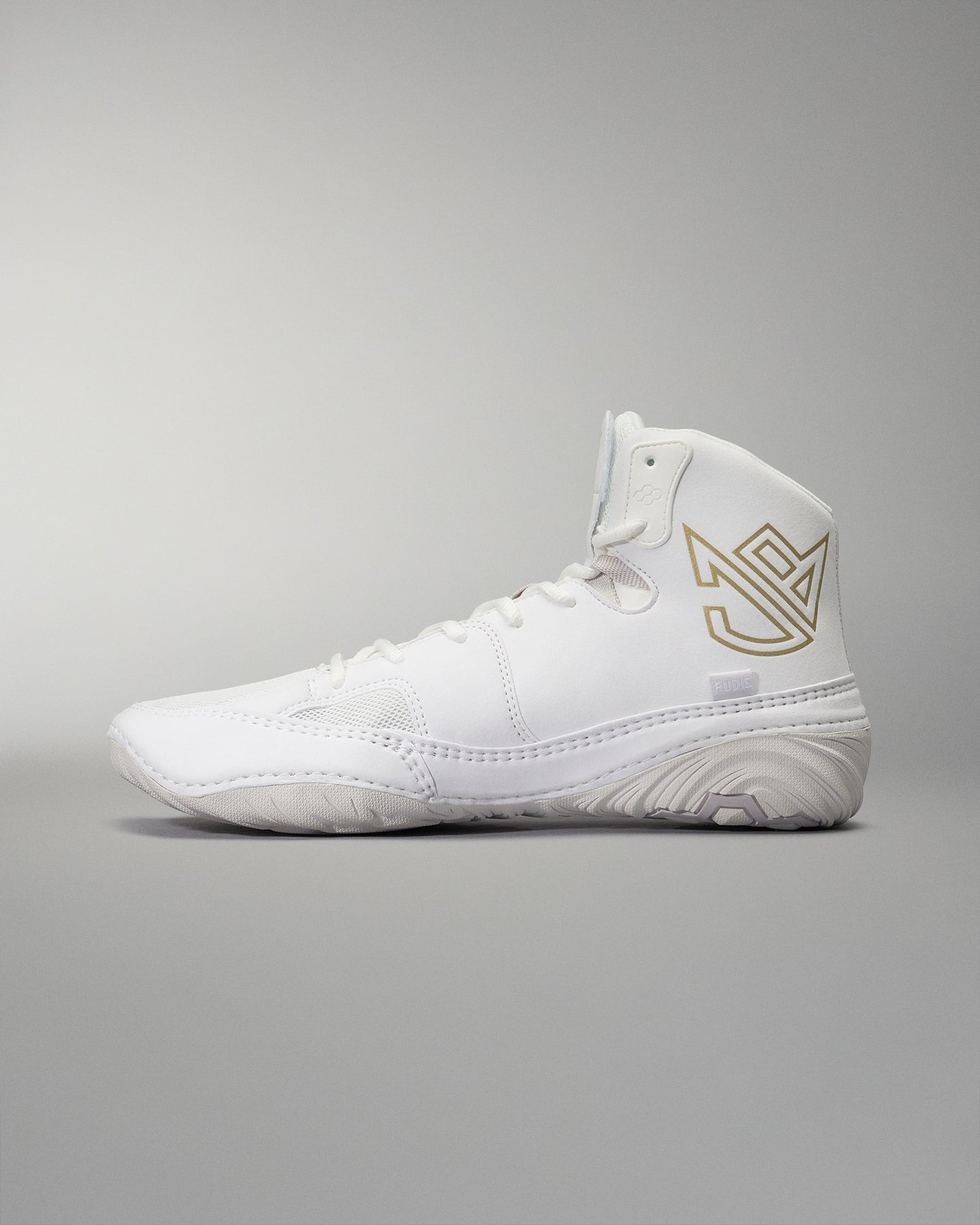 High-top athletic shoe presented in white with a textured sole, gold logo, and padded collar, designed for comfort and performance against a soft gray background.