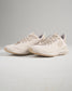 Light beige running shoes featuring a breathable mesh upper and textured sole designed for comfort and performance