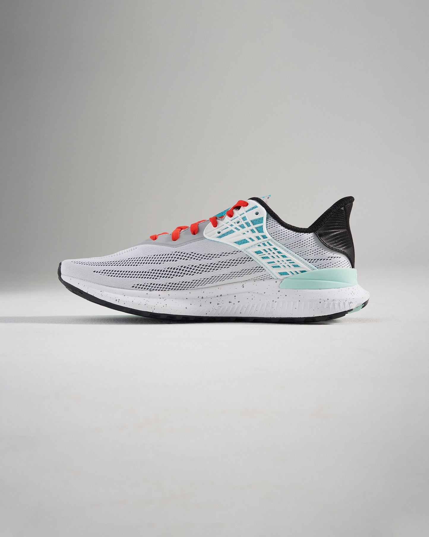 A stylish pair of modern running shoes featuring a white mesh upper with black aqua and red accents designed for comfort and performance