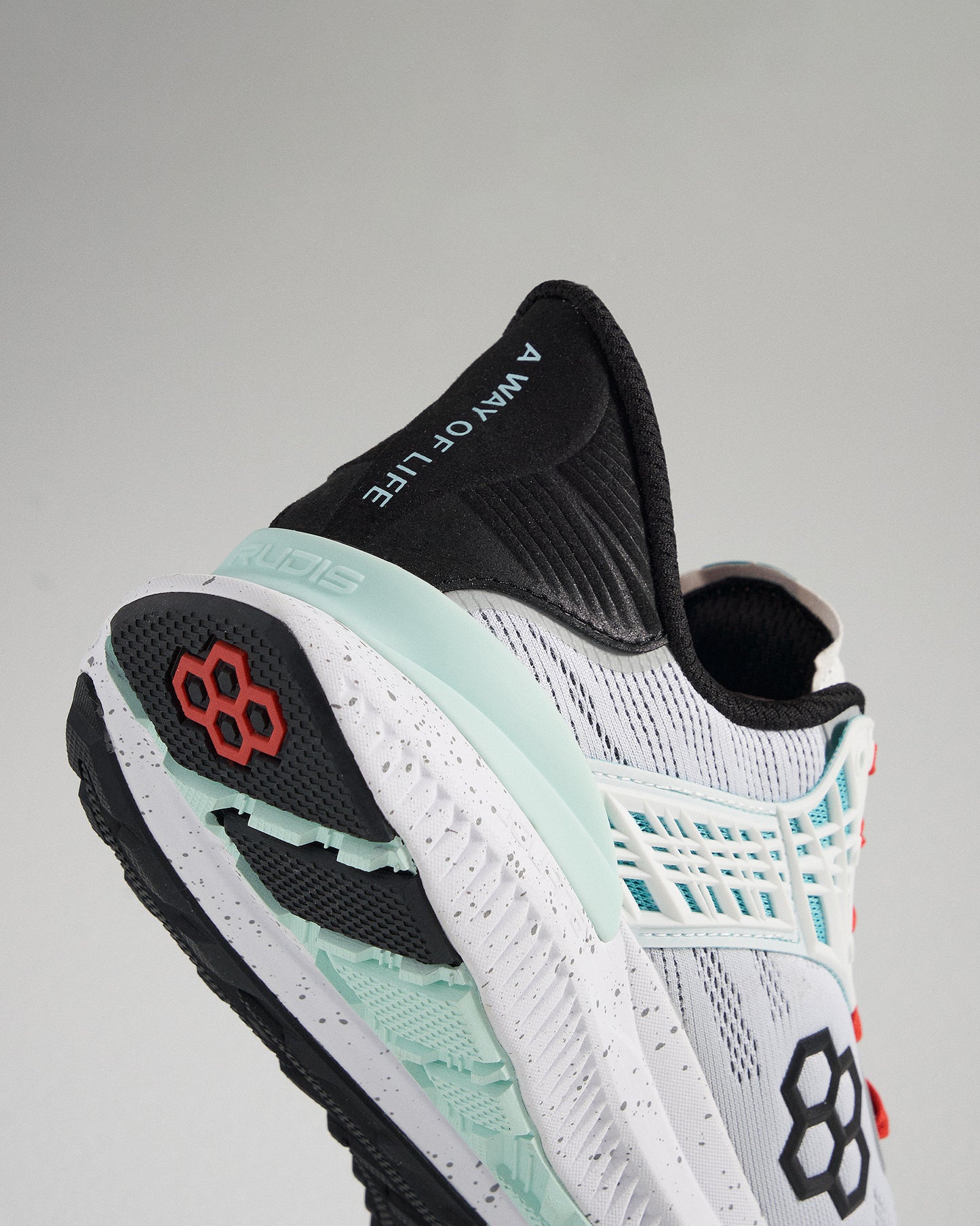 A close-up view of a sleek athletic shoe featuring a lightweight design with a distinctive black and white upper mint green accents and a textured sole for improved traction