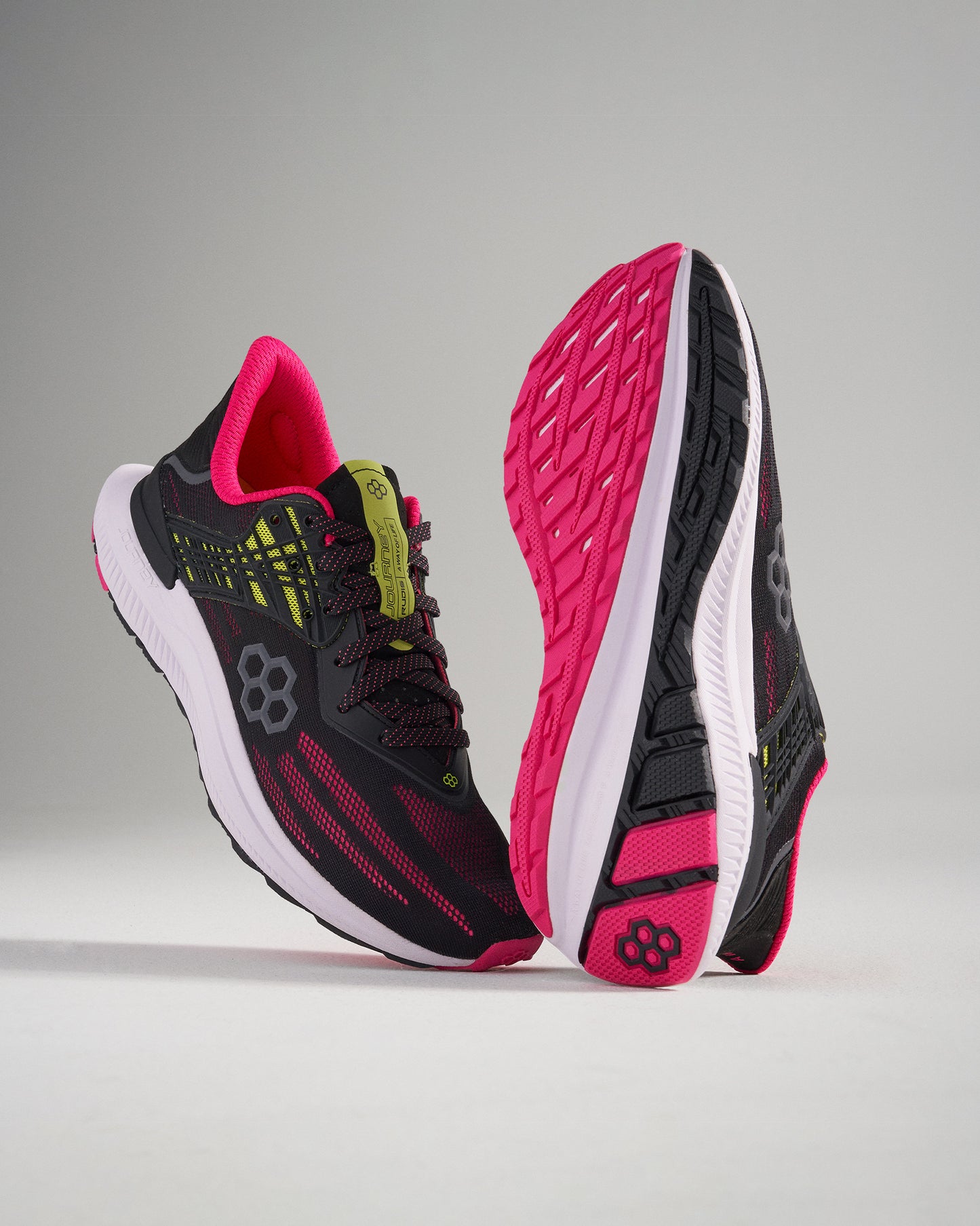 This image features a pair of modern black and pink running shoes designed for style and performance showcasing a breathable mesh upper and a textured sole