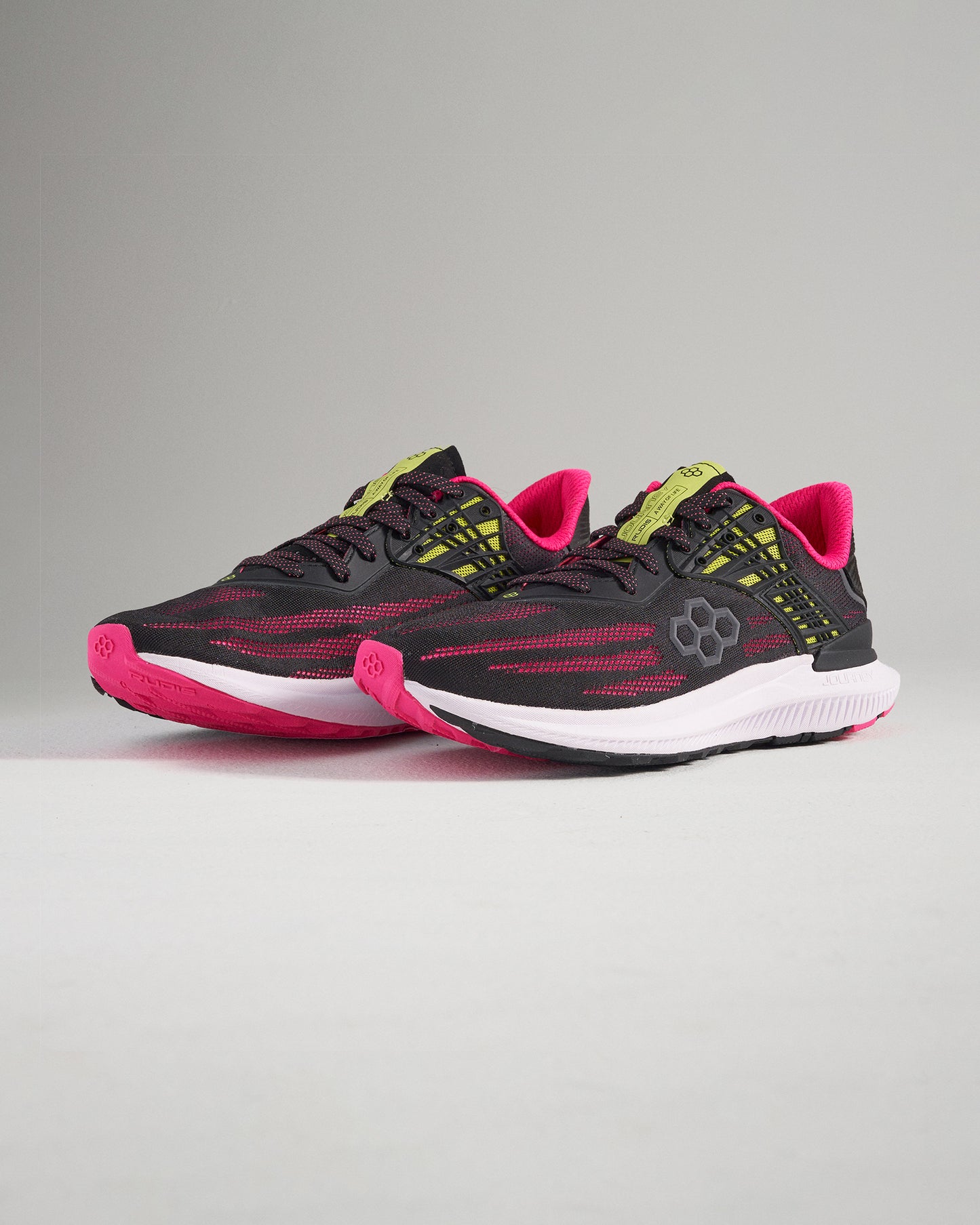 A modern pair of black and pink running shoes featuring a breathable upper and a durable sole designed for both performance and style