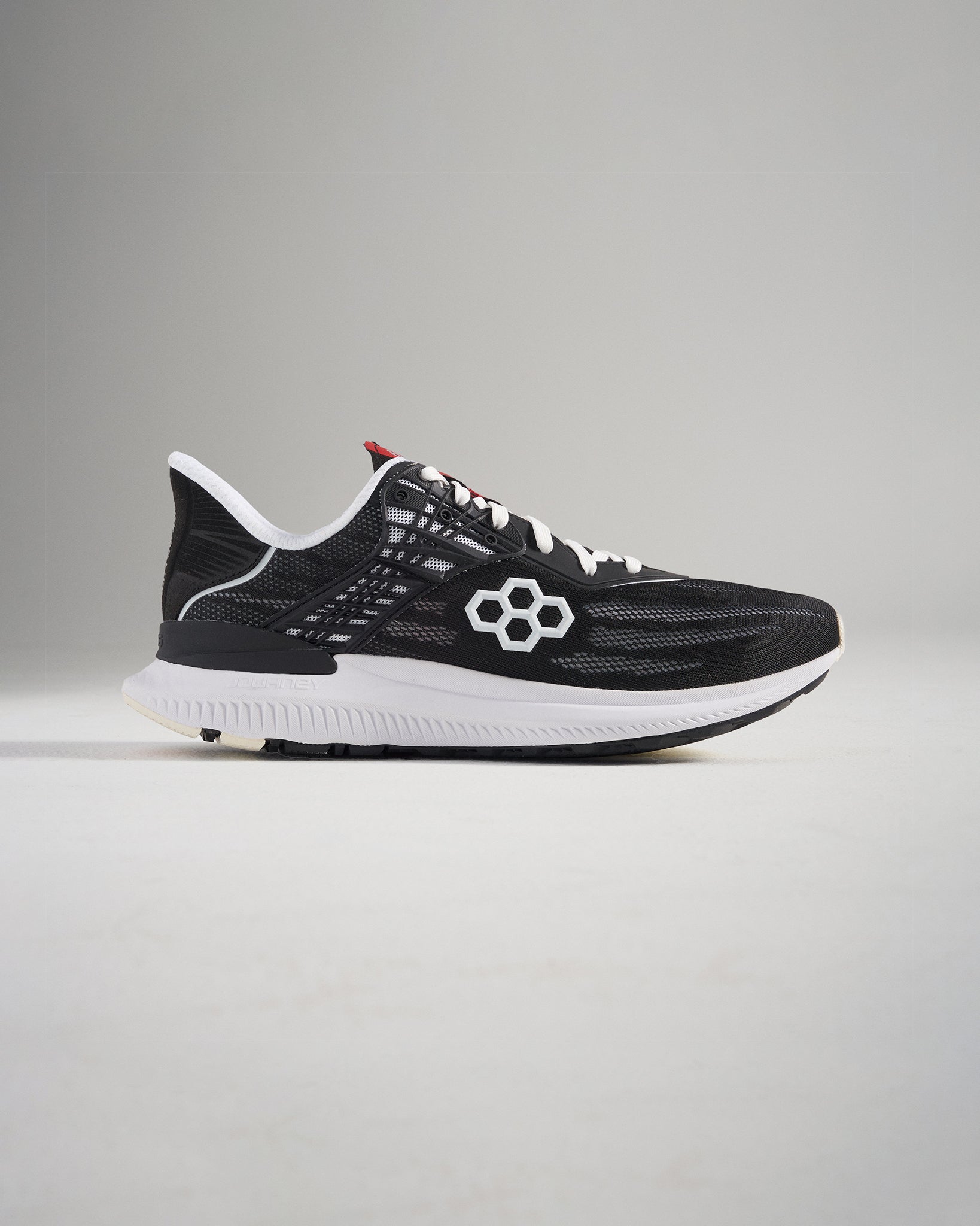 A modern black running shoe with a breathable mesh upper featuring a stylish design and durable grip for performance