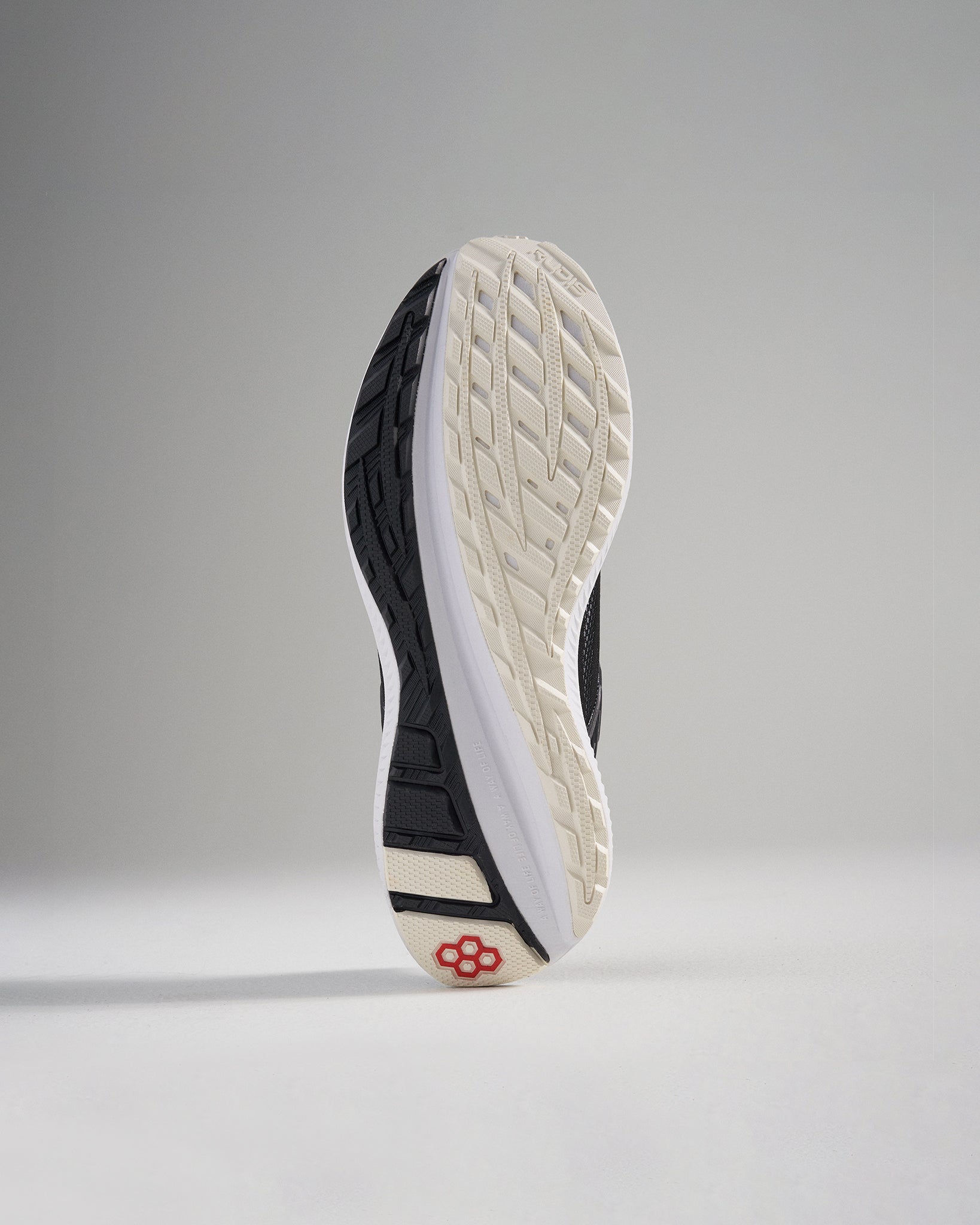 A close-up view of a shoes sole featuring a textured black and white design for traction and durability