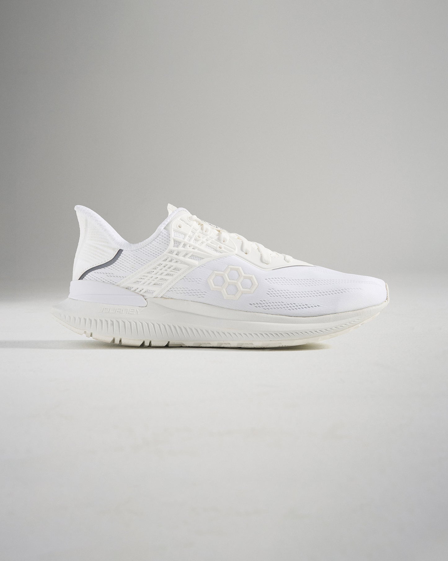 A sleek pair of white running shoes showcasing a modern design with breathable mesh upper and lightweight construction