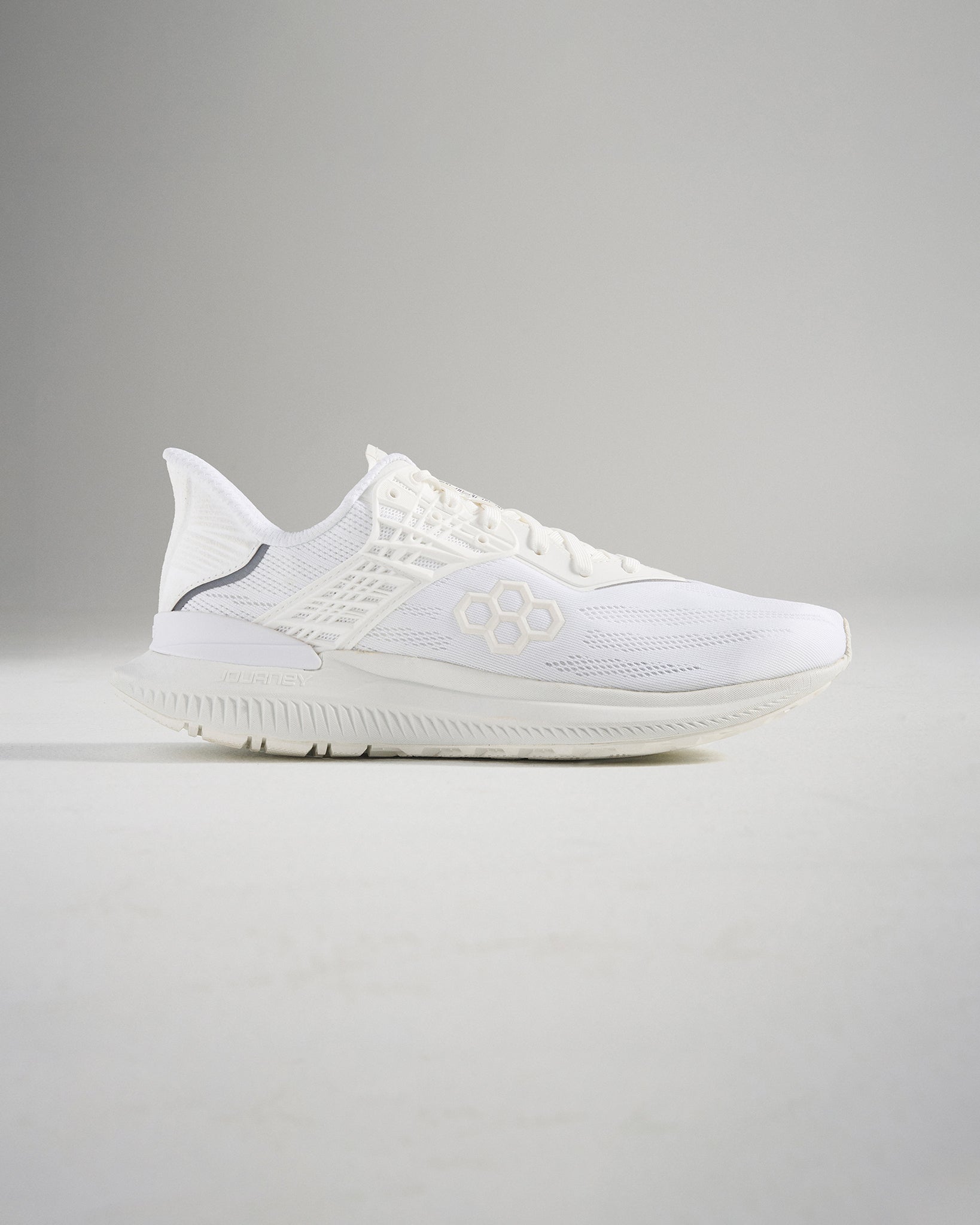 A sleek pair of white running shoes showcasing a modern design with breathable mesh upper and lightweight construction