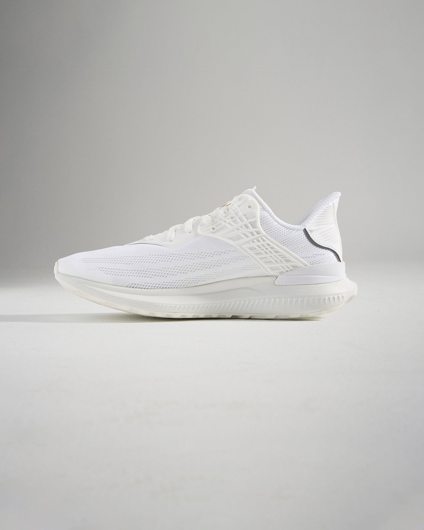 A stylish white athletic shoe showcasing a breathable mesh upper and a sleek design ideal for running and casual wear