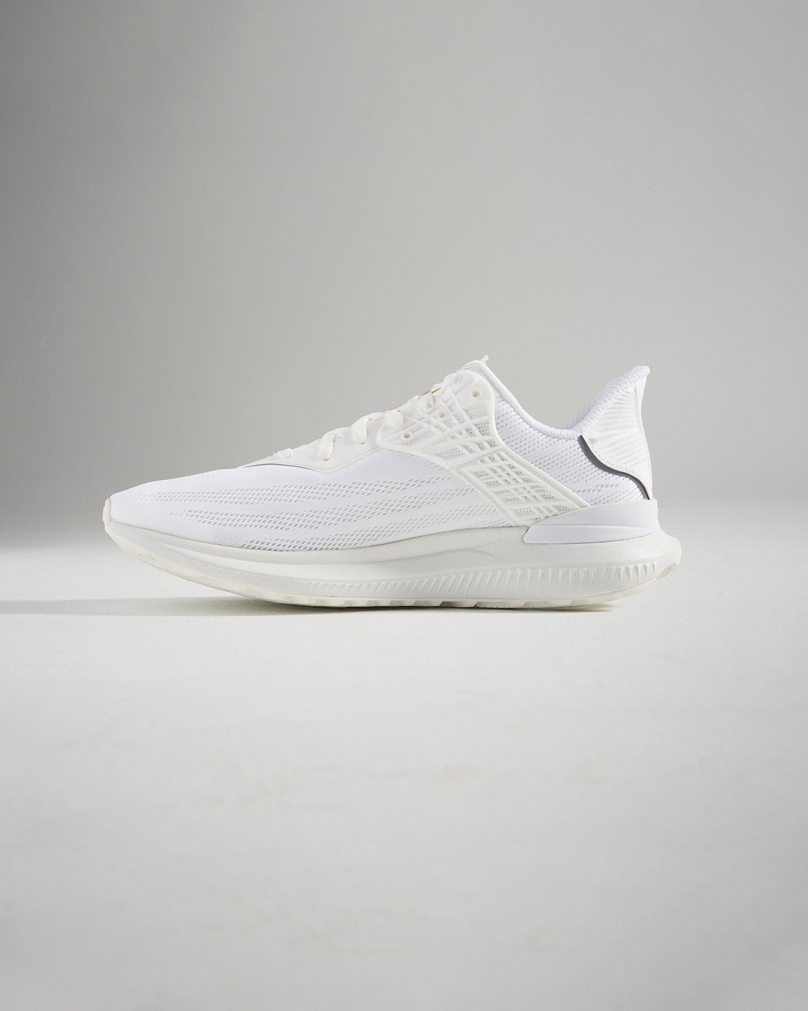 A stylish white athletic shoe showcasing a breathable mesh upper and a sleek design ideal for running and casual wear