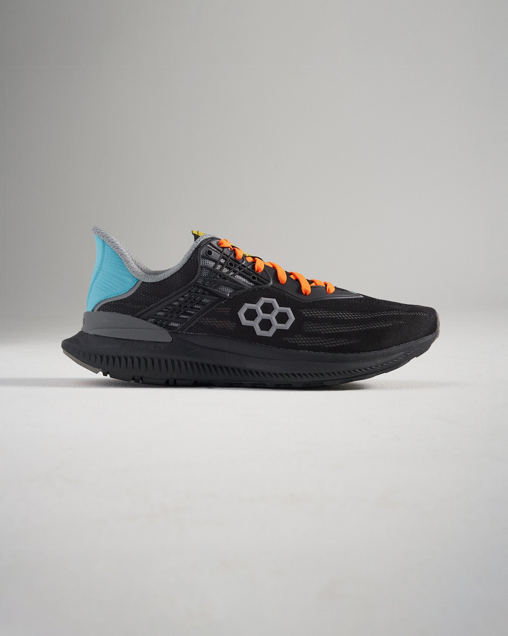 A modern black athletic shoe with vibrant orange laces and a blue heel featuring a mesh upper and durable sole