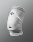 A white knee sleeve designed for sports protection featuring a hexagonal logo and a branded label at the bottom