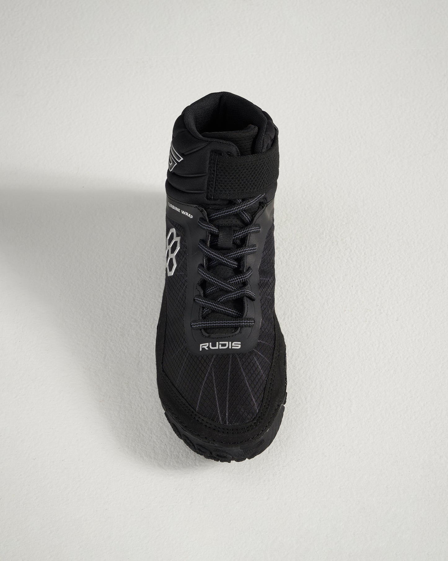 A top view of a black wrestling shoe featuring a high collar textured surface and laces for a secure fit designed for performance and support in competitive sports