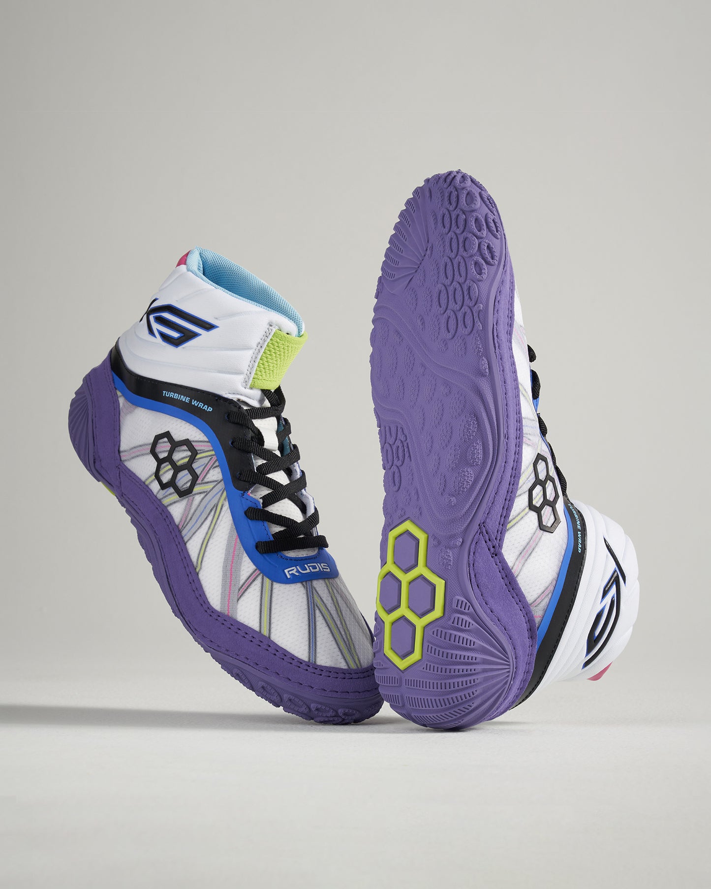 A pair of modern wrestling shoes featuring a vibrant design with a white base purple soles and multicolored accents for enhanced performance and style