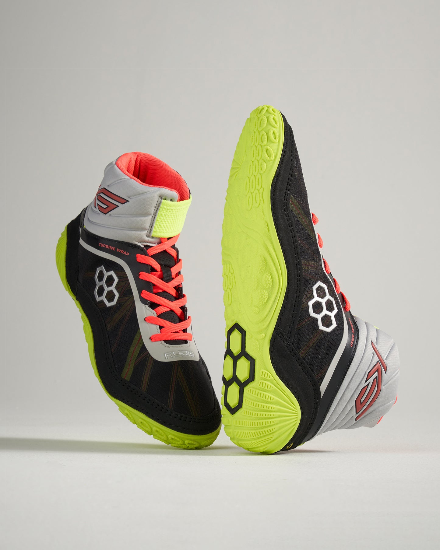 A pair of high-top black athletic shoes with vibrant neon green soles and red laces designed for performance and comfort in sports activities