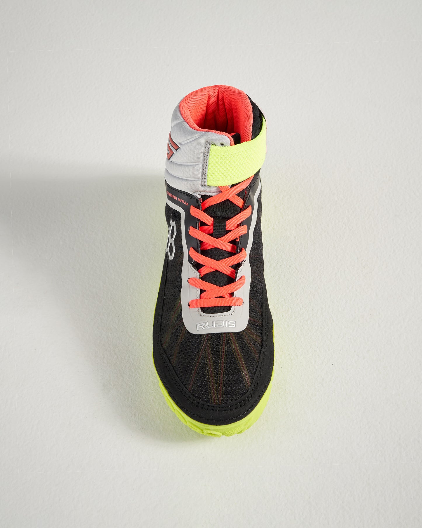 A top view of a black high-top athletic shoe with vibrant pink laces and a bright yellow accent near the ankle designed for performance and style