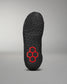 The underside of a shoe displays a black textured sole with a central red and black honeycomb design, enhancing grip and performance against a neutral gray background.