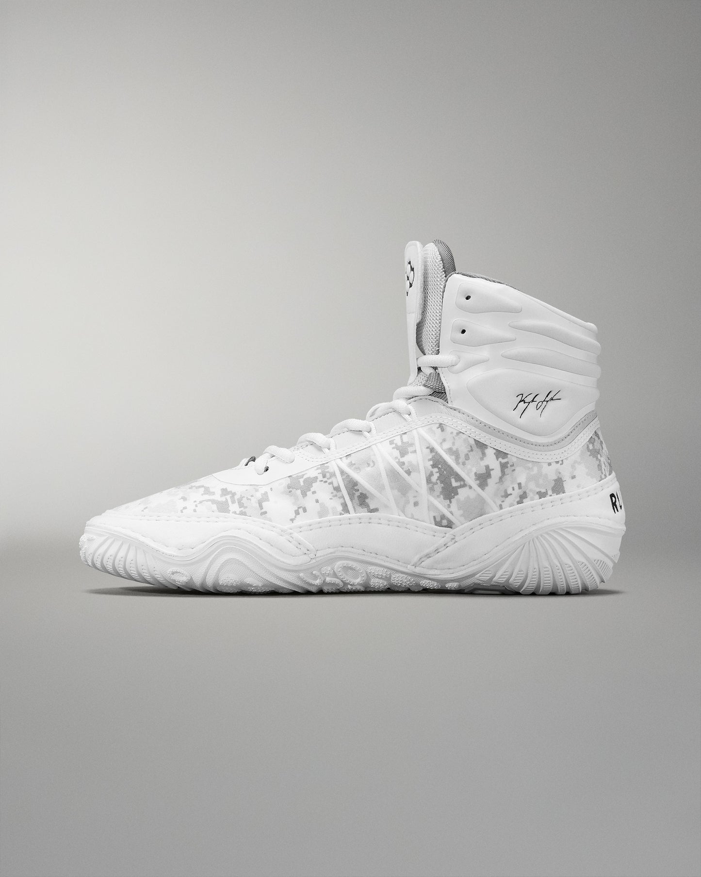 A high-top athletic shoe in white with a subtle camouflage pattern includes a padded collar and textured sole for grip, suitable for sports activities.