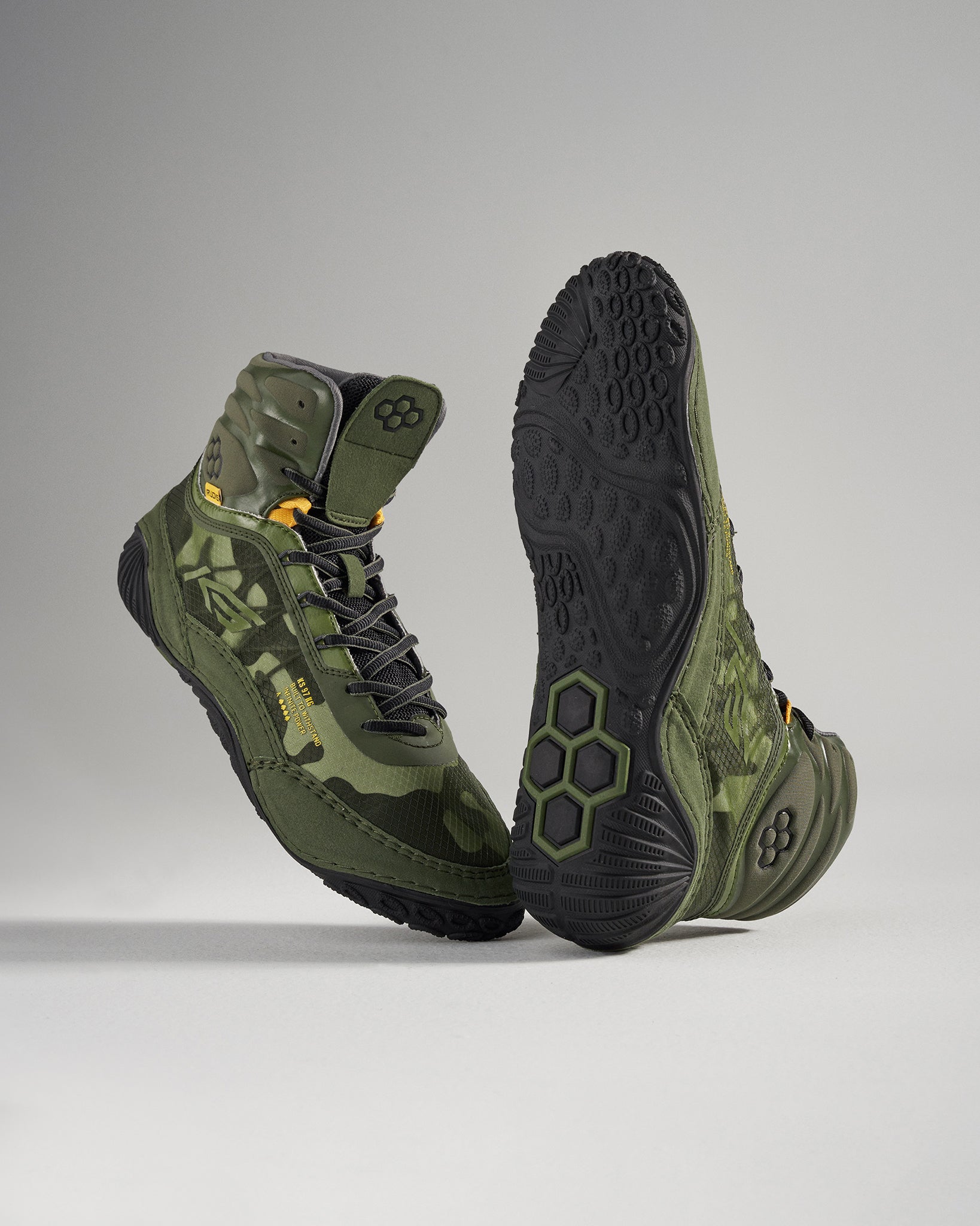 A pair of high-top green camouflage athletic shoes with a textured black sole designed for performance and style