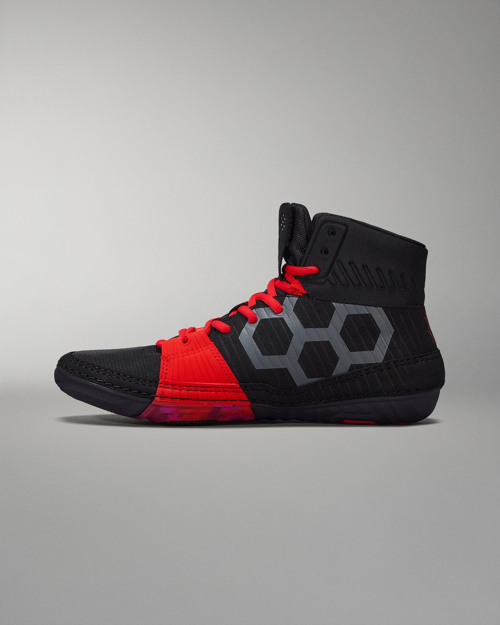 RUDIS black wrestling shoe with red accents, mesh upper, and a segmented outsole for traction - inner side shoe view