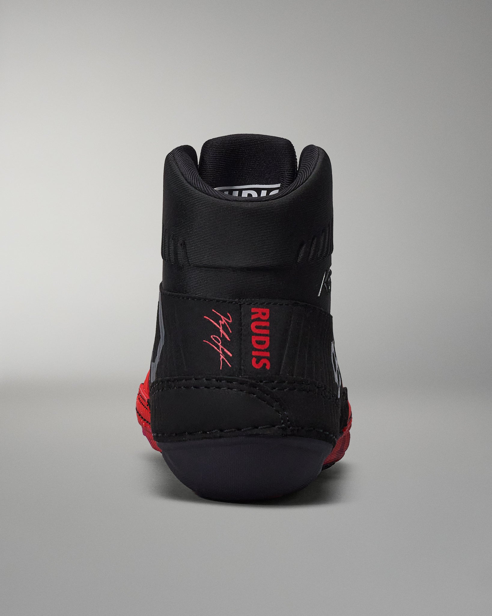 Back view of RUDIS wrestling shoe with black and red segmented sole for traction and flexibility