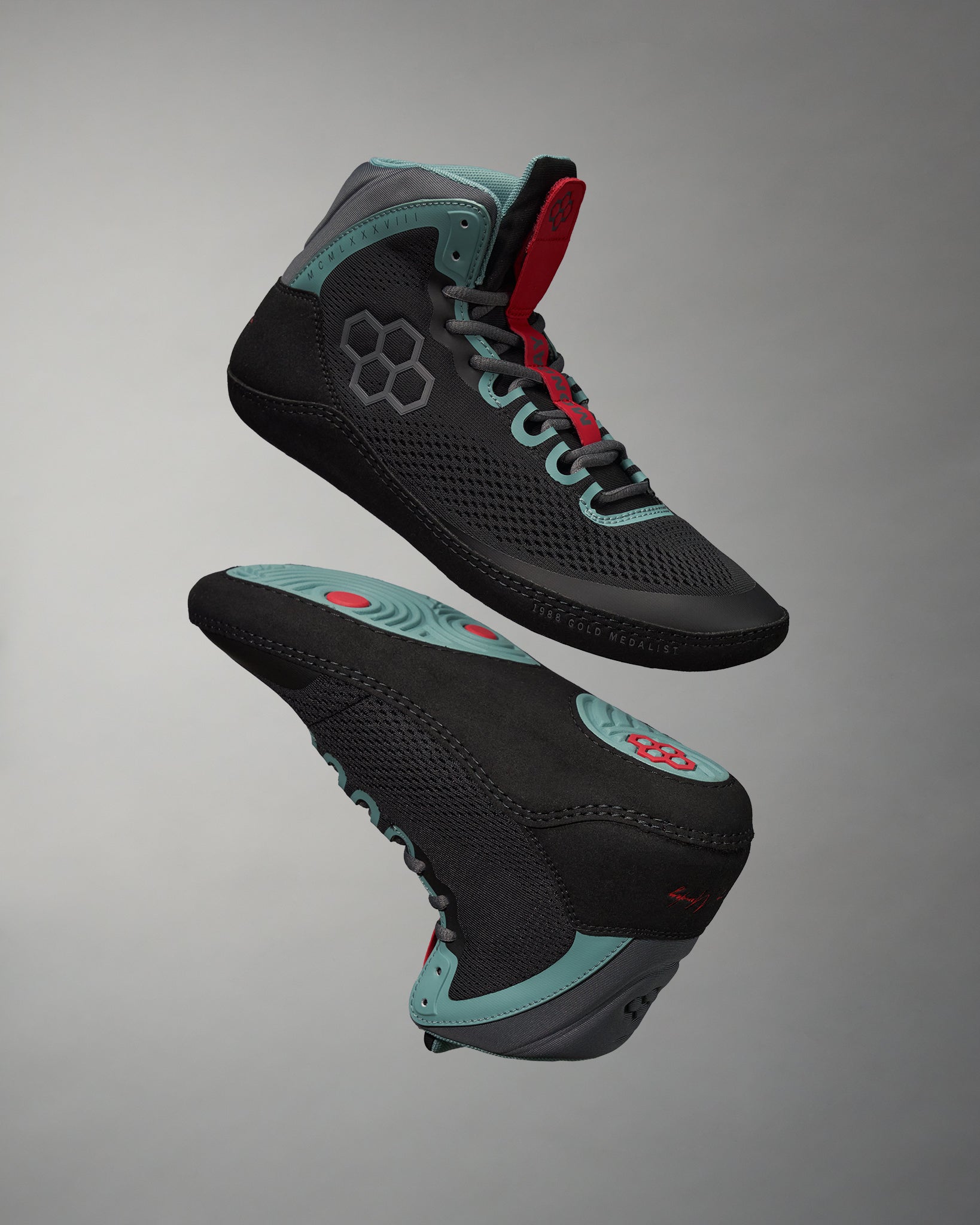 A pair of stylish black and teal high-top athletic shoes designed for performance featuring a breathable mesh upper and a textured sole for enhanced grip